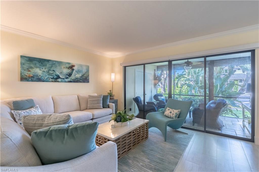 1071 8th Street South, Unit 103 Naples, FL 34102 - Photo 4 of 31 a living room with furniture and a large window