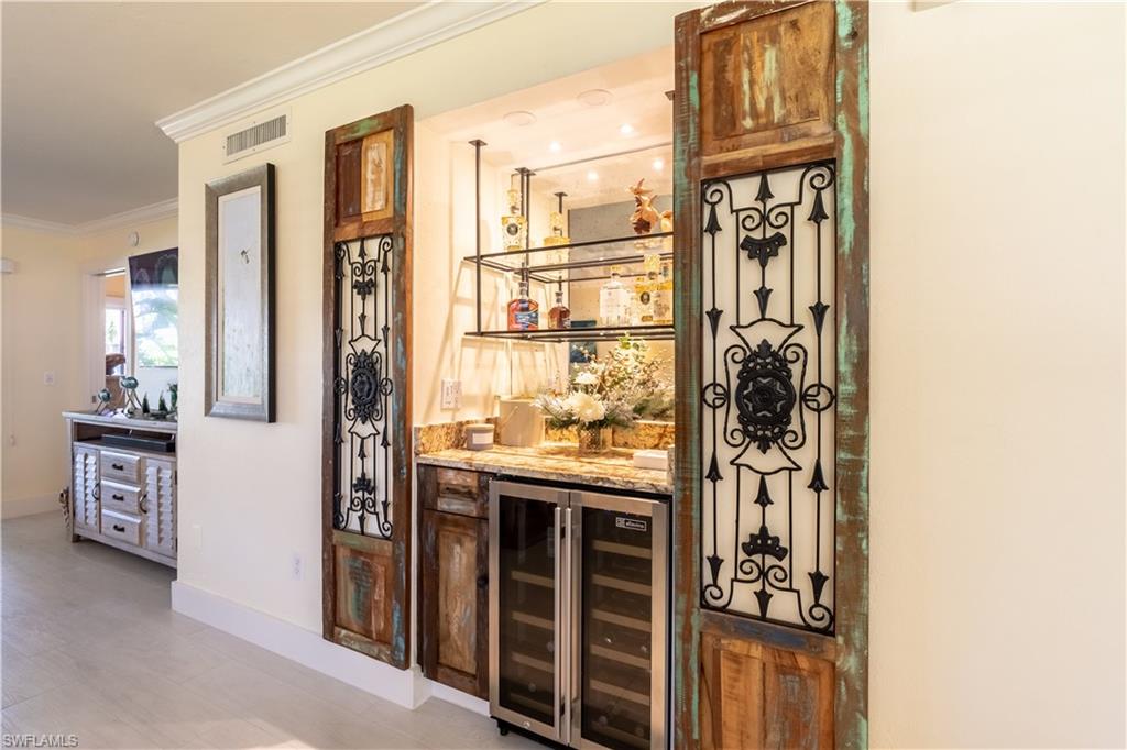 1071 8th Street South, Unit 103 Naples, FL 34102 - Photo 6 of 31 a view of kitchen with granite countertop a refrigerator and a stove