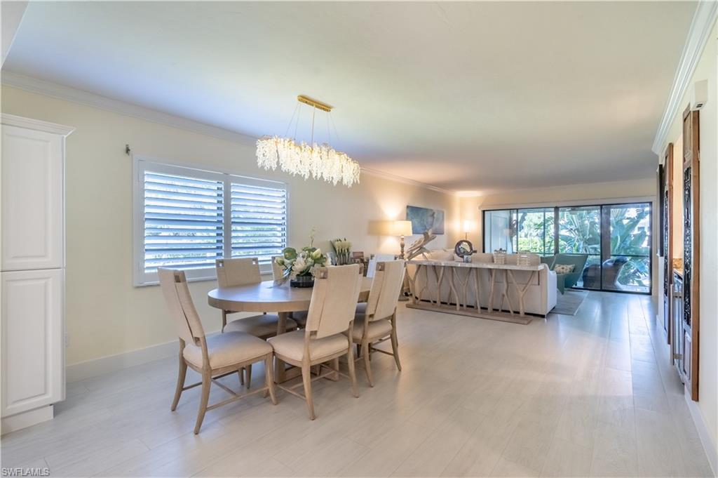 1071 8th Street South, Unit 103 Naples, FL 34102 - Photo 8 of 31 a living room with furniture and a large window