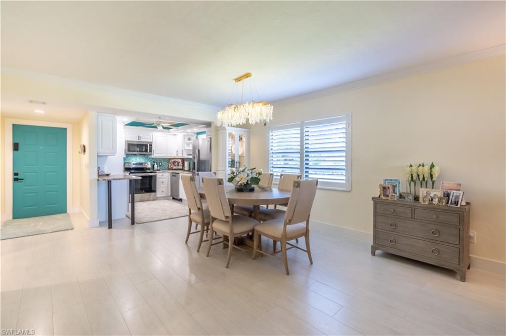1071 8th Street South, Unit 103 Naples, FL 34102 - Photo 9 of 31 a dining room with furniture and window