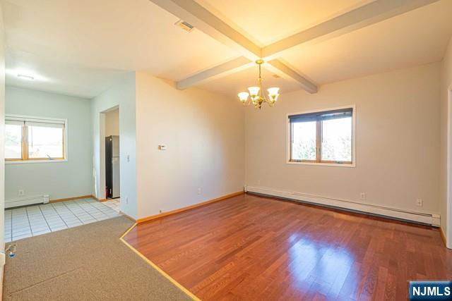an empty room with a chandelier fan and windows