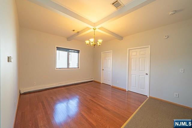 112 Prospect Street, Unit 2 Garfield, NJ 07026 - Photo 2 of 14 an empty room with a chandelier fan and windows