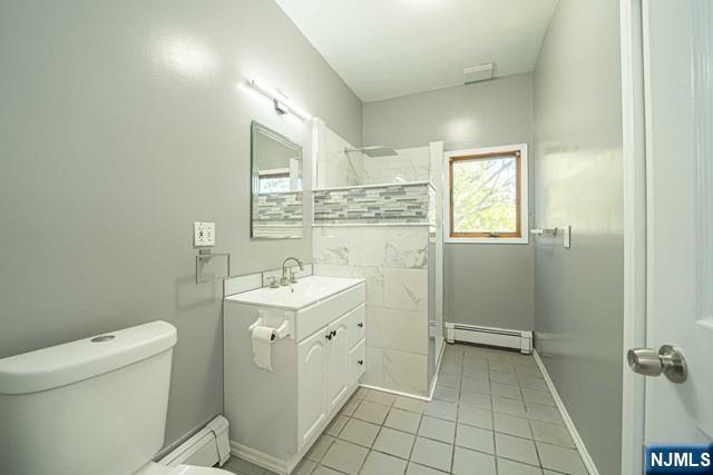 112 Prospect Street, Unit 2 Garfield, NJ 07026 - Photo 6 of 14 a spacious bathroom with a granite countertop sink a toilet and a mirror