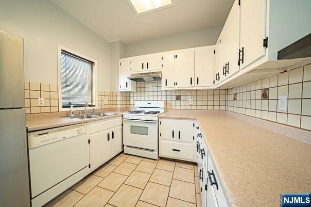 112 Prospect Street, Unit 2 Garfield, NJ 07026 - Photo 7 of 14 a kitchen with granite countertop white cabinets and white appliances