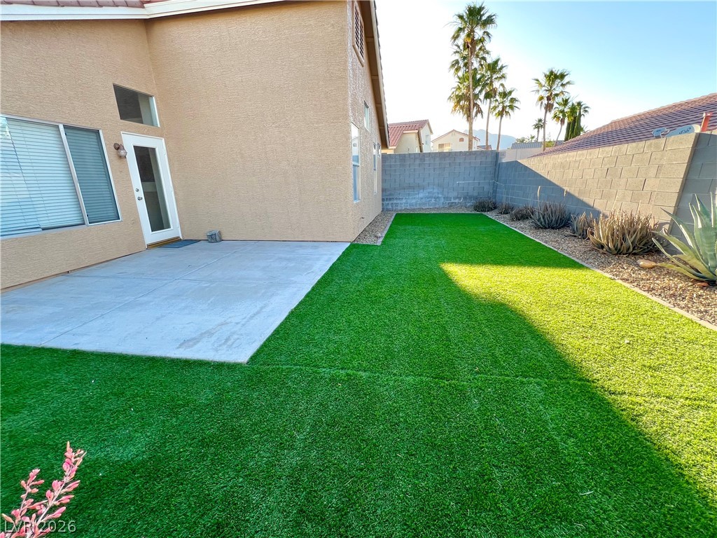 9708 Ridge Creek Place Las Vegas, NV 89134 - Photo 28 of 34 A private yard with artificial turf and a patio offers low-maintenance outdoor enjoyment.
