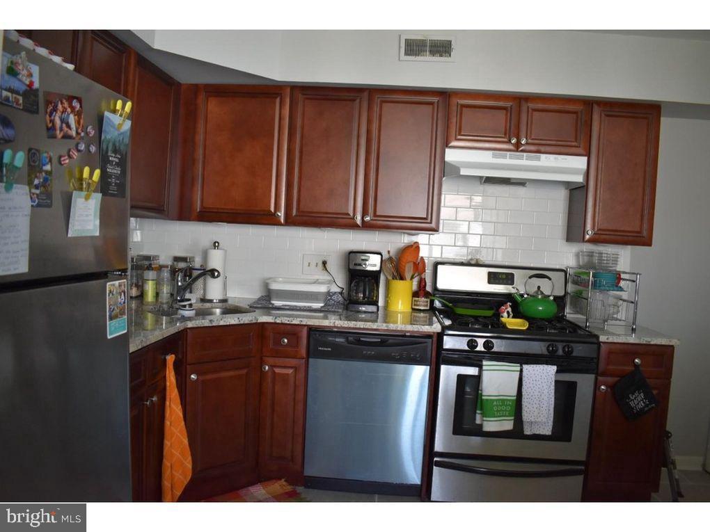 33 Buttonwood Road Voorhees, NJ 08043 - Photo 11 of 14 a kitchen with stainless steel appliances granite countertop a refrigerator a sink dishwasher and wooden cabinets