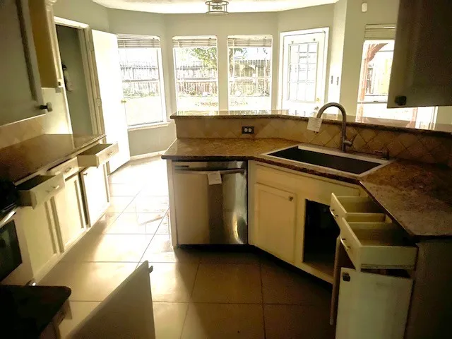 a utility room with sink dryer and washer