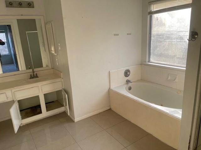 3807 Timber Rail Drive Humble, TX 77396 - Photo 7 of 13 a bathroom with a tub a sink and a window