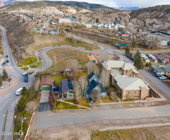 an aerial view of residential houses with outdoor space