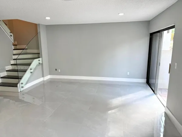 a view of an empty room with stairs