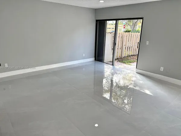 a view of empty room with floor to ceiling window