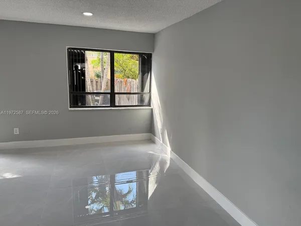 a view of an empty room with a window
