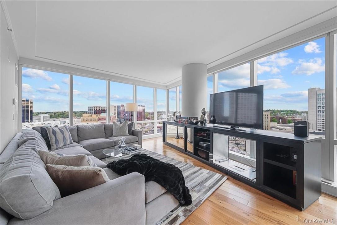 1 Renaissance Square, Unit 14D White Plains, NY 10601 - Photo 11 of 24 a living room with furniture large windows and wooden floor