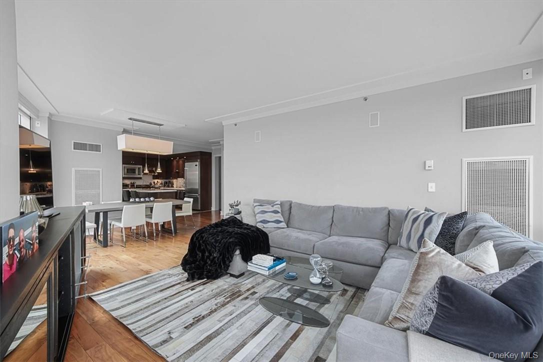 1 Renaissance Square, Unit 14D White Plains, NY 10601 - Photo 14 of 24 a living room with furniture a flat screen tv and a rug