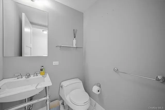 a white toilet sitting next to a bathroom sink