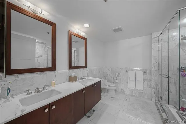 a bathroom with a double vanity sink mirror double and shower