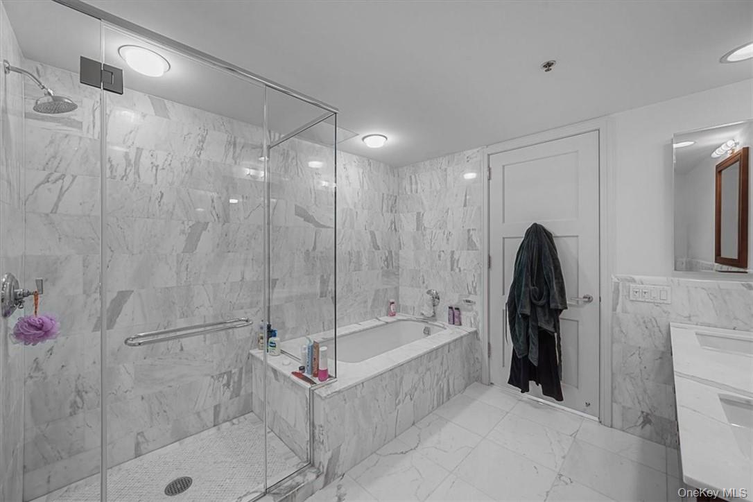 1 Renaissance Square, Unit 14D White Plains, NY 10601 - Photo 21 of 24 a bathroom with a tub and a shower