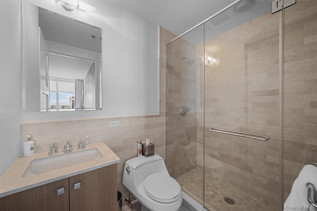 1 Renaissance Square, Unit 14D White Plains, NY 10601 - Photo 23 of 24 a bathroom with a sink toilet and shower