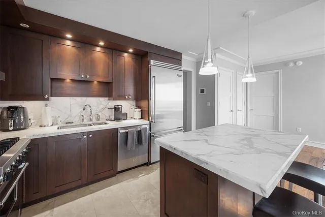 a kitchen with kitchen island a sink stove and refrigerator