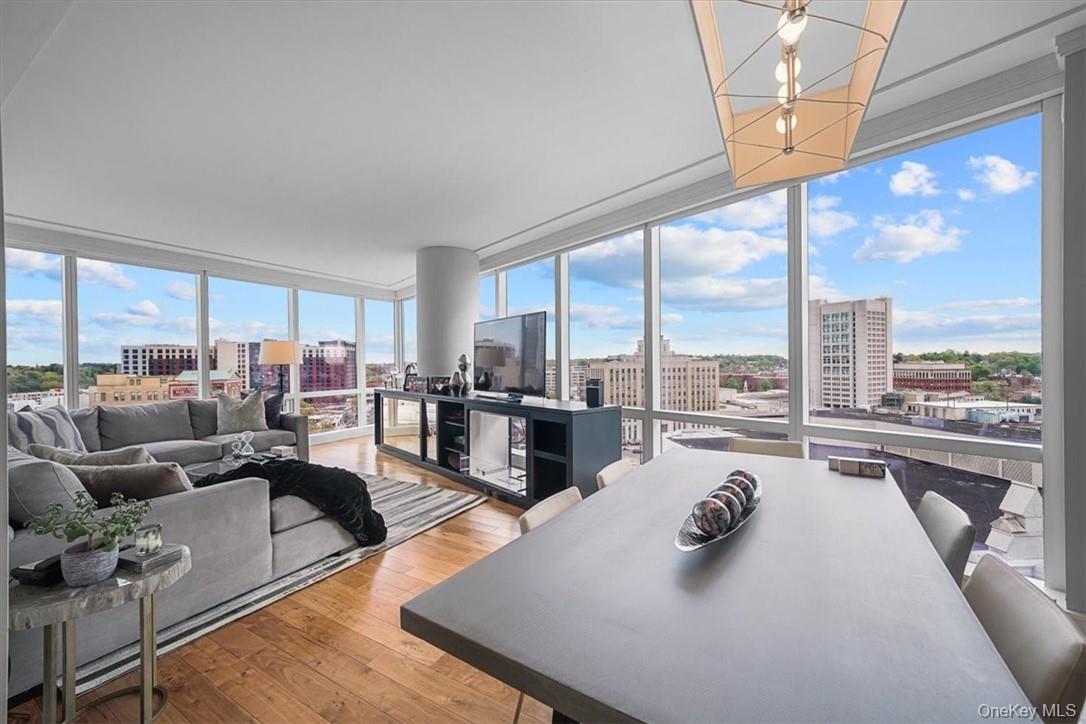 1 Renaissance Square, Unit 14D White Plains, NY 10601 - Photo 10 of 24 a living room with furniture large windows and wooden floor