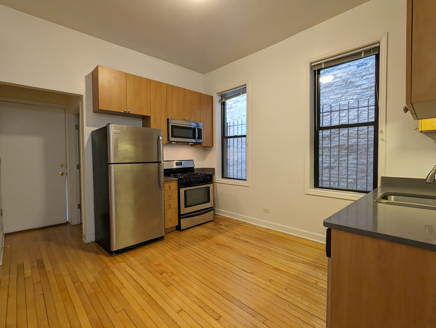 2134 West Concord Place, Unit 1R Chicago, IL 60647 - Photo 11 of 18 a kitchen with stainless steel appliances a refrigerator and a stove top oven