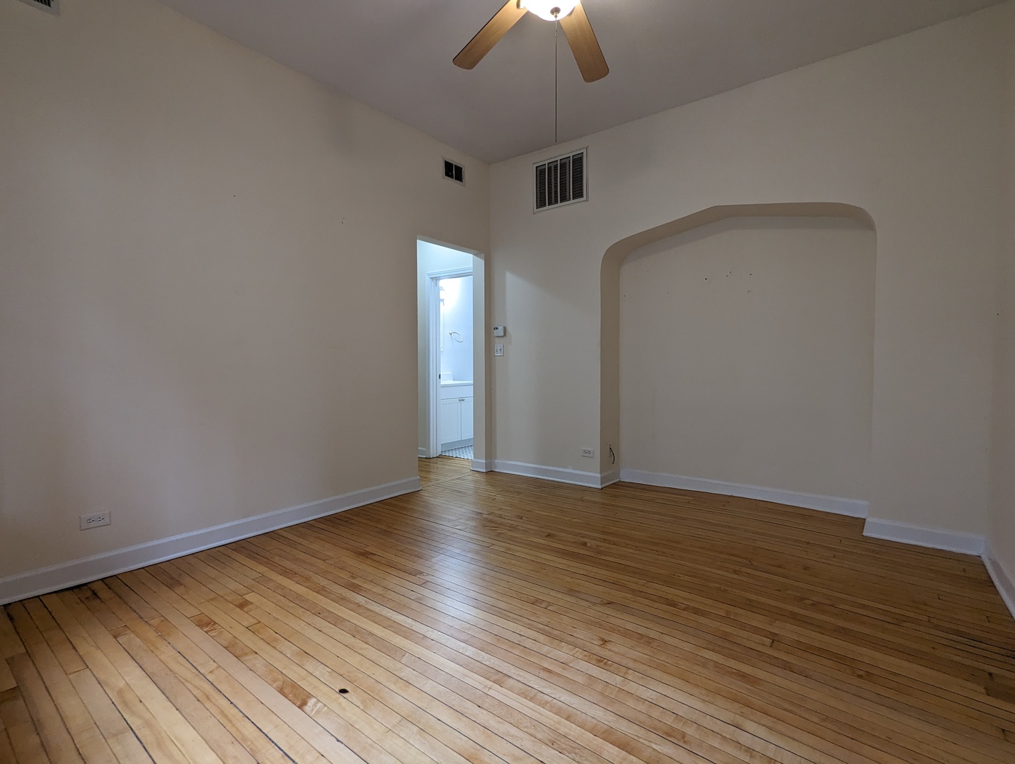 2134 West Concord Place, Unit 1R Chicago, IL 60647 - Photo 4 of 18 a view of an empty room with wooden floor ceiling fan