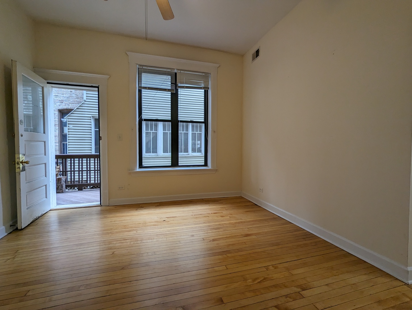 2134 West Concord Place, Unit 1R Chicago, IL 60647 - Photo 5 of 18 a view of an empty room with wooden floor and a window