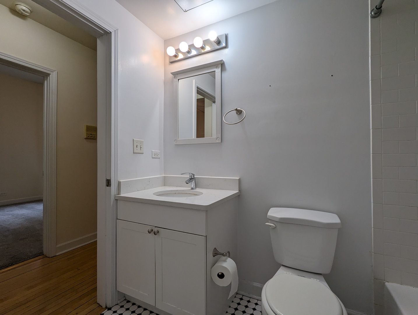 2134 West Concord Place, Unit 1R Chicago, IL 60647 - Photo 7 of 18 a bathroom with a toilet a sink and mirror