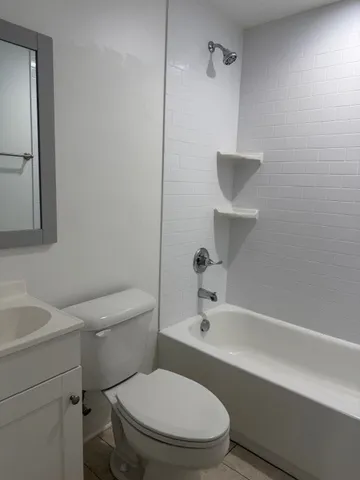 a white toilet sitting next to a bathroom sink