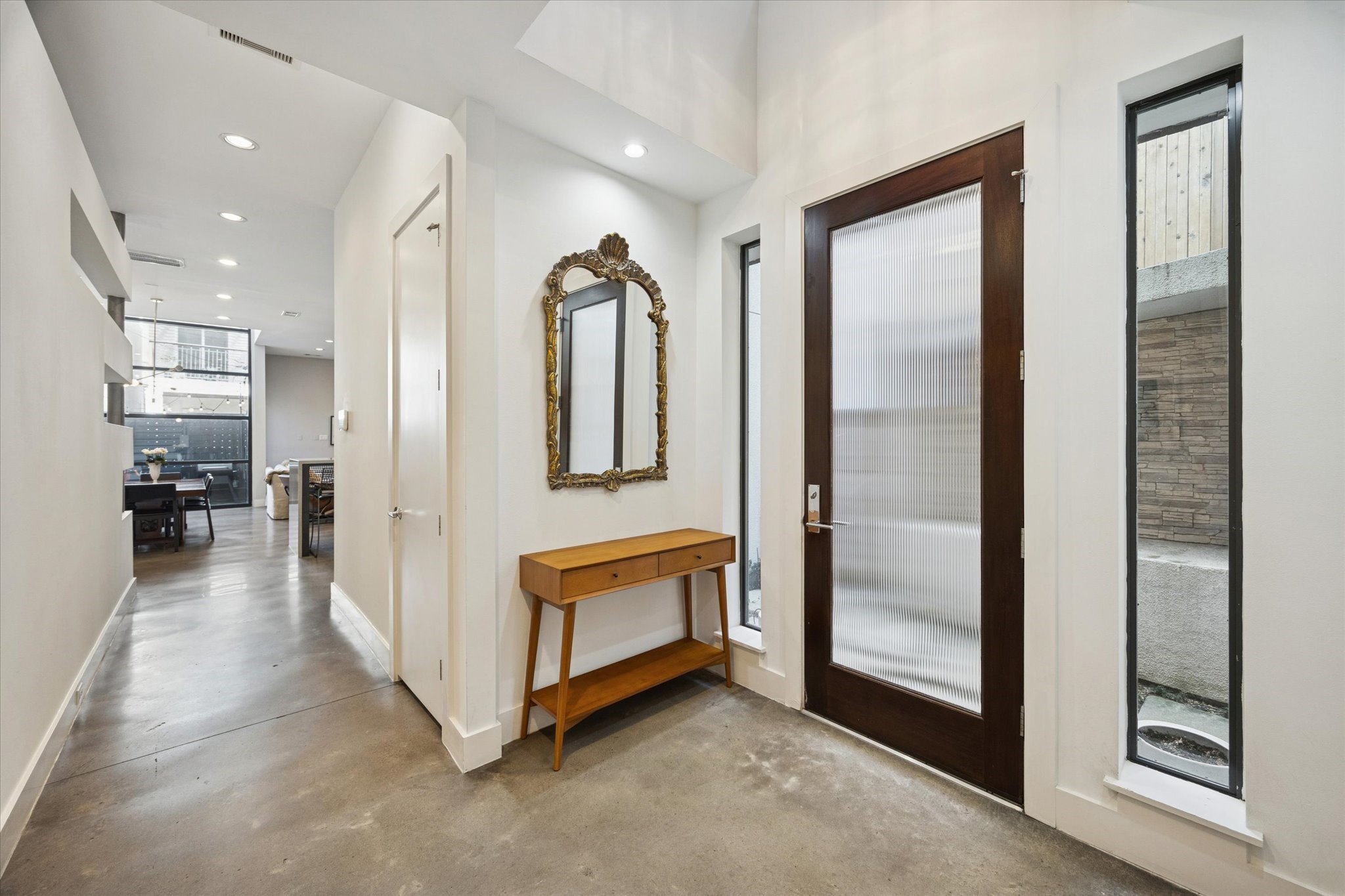 6504 Rodrigo Street, Unit B Houston, TX 77007 - Photo 3 of 29 A bright, light-filled foyer welcomes you with polished concrete floors and soaring ceilings.