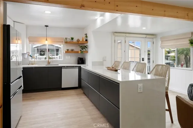 a kitchen with stainless steel appliances a stove a sink a refrigerator and cabinets