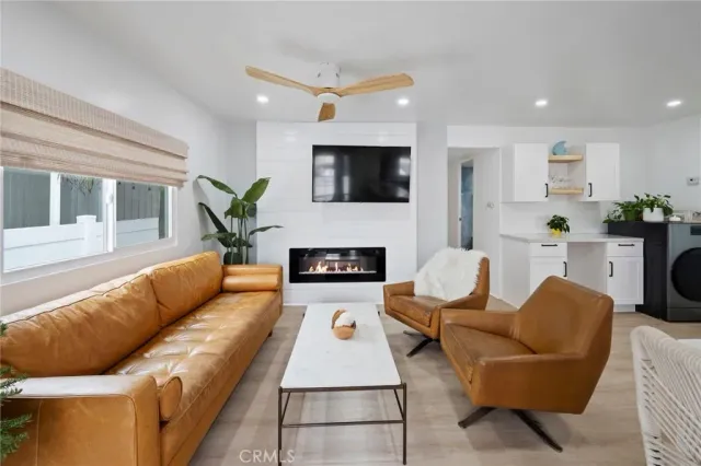 a living room with furniture a window and a chandelier