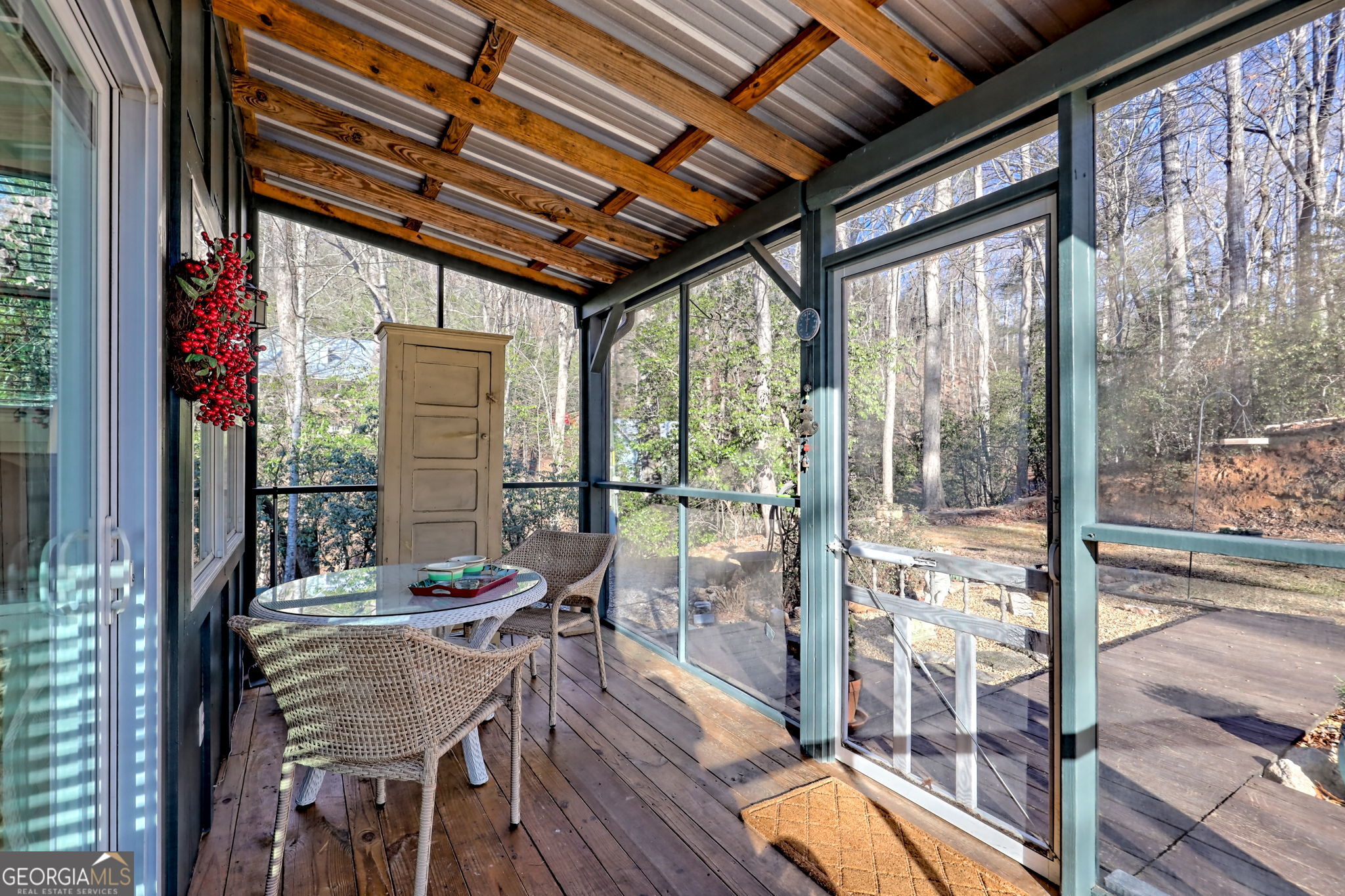 1063 Joe Davis Road Tiger, GA 30576 - Photo 28 of 39 a view of a patio with table and chairs and wooden floor