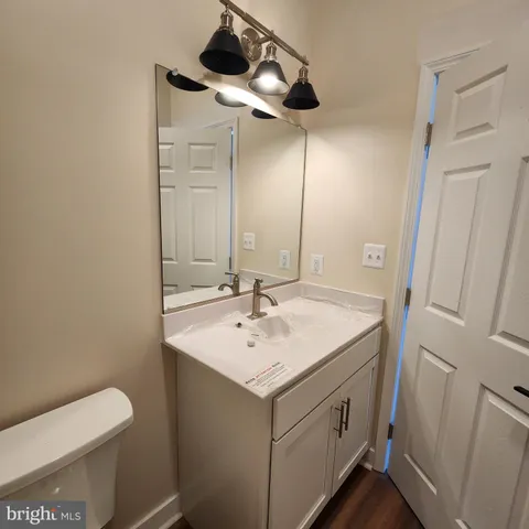 a bathroom with a sink toilet and mirror
