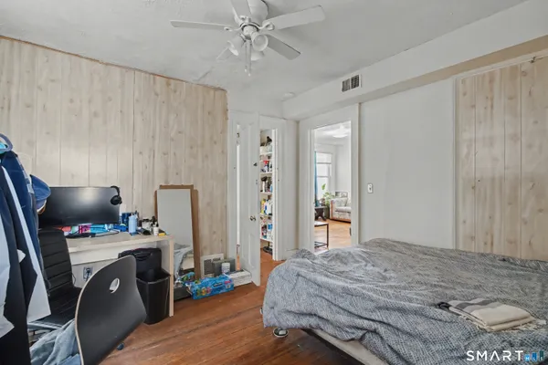 a bedroom with a bed and a chandelier