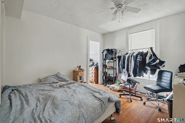 a bedroom with a bed and a desk