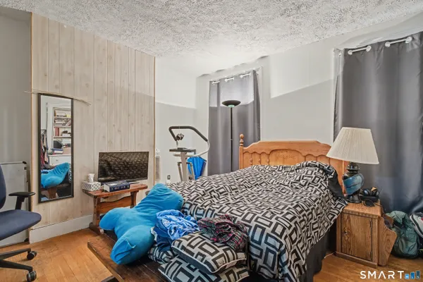 a bedroom with a bed and flat screen tv