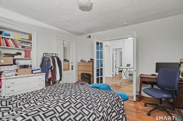 a bedroom with a bed a desk and chair