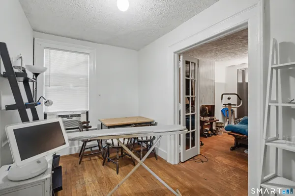 a view of a dining room with furniture and a flat screen tv
