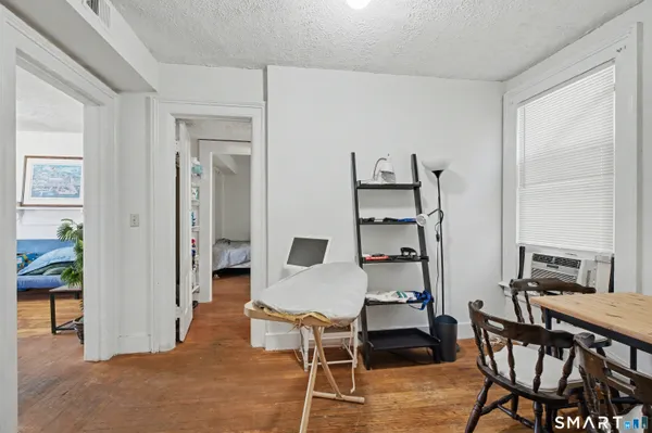 a view of a dining room with furniture and wooden floor