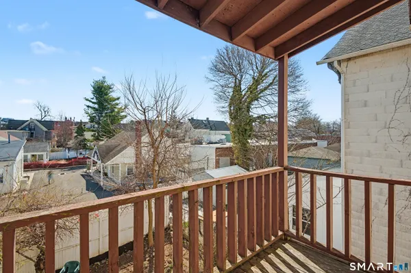 a view of a balcony with wooden fence