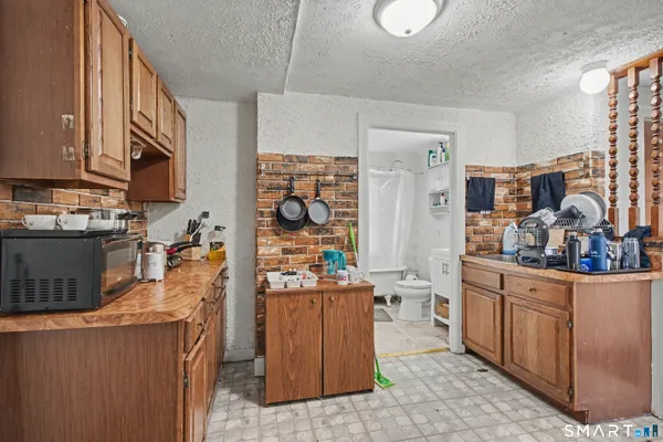 a kitchen filled with stainless steel appliances kitchen island granite countertop a table and chairs in it