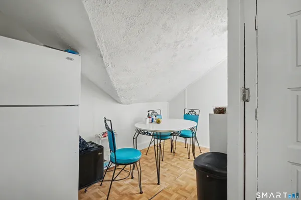 a living room with furniture a rug and white walls