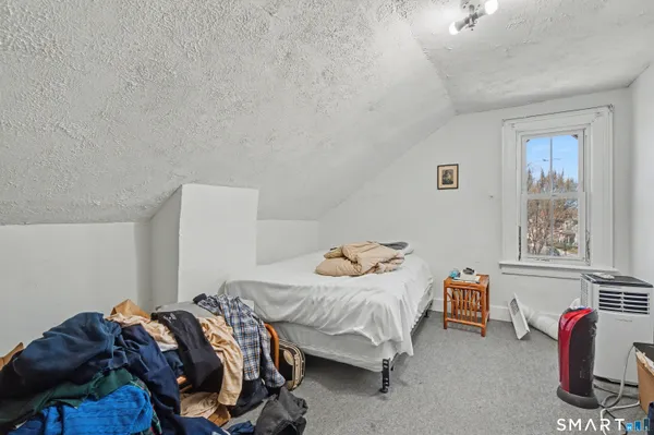 a bedroom with bed and a window