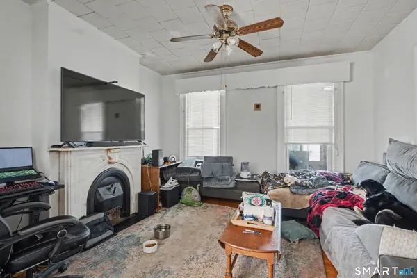 a living room with furniture a fireplace and a flat screen tv