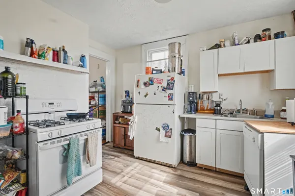 a kitchen with a stove top oven and cabinets