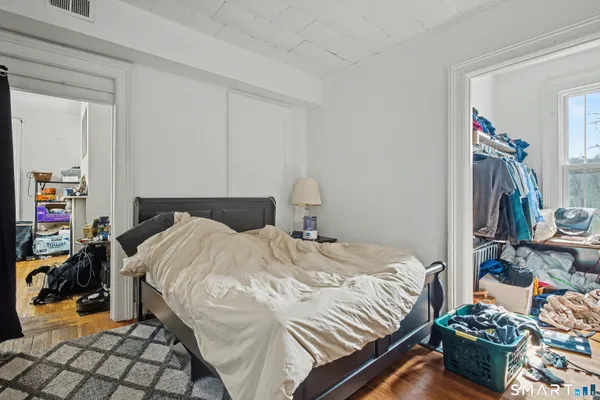 a bedroom with a bed and a tv