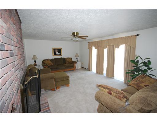 Living Room. Neutral carpet and walls can accommodate any decorating style.  Access to the deck is a plus when entertaining.