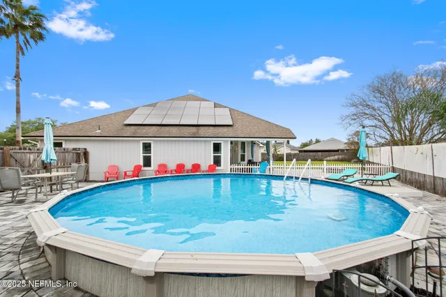 a view of a patio with swimming pool table and chairs