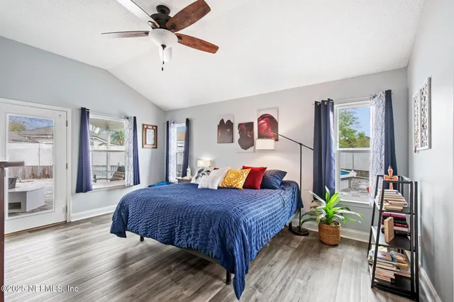 a bedroom with a bed bookshelf and a window